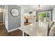 Bright dining area with white table and chairs leading to the modern kitchen with stainless steel appliances at 303 Caroline Ave, Lowell, NC 28098