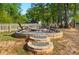 Charming backyard fire pit area with chairs and a white picket fence, perfect for outdoor entertaining at 303 Caroline Ave, Lowell, NC 28098