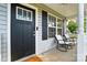 Inviting front porch with rocking chairs, offering a relaxing outdoor space with a view of the neighborhood at 303 Caroline Ave, Lowell, NC 28098