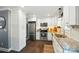 Modern kitchen featuring stainless steel appliances, granite countertops, and white cabinetry at 303 Caroline Ave, Lowell, NC 28098
