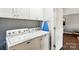 Laundry room featuring a white washer and dryer and white cabinets at 303 Caroline Ave, Lowell, NC 28098