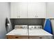 Laundry room featuring a white washer and dryer and white cabinets at 303 Caroline Ave, Lowell, NC 28098