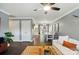 Open-concept living room flowing into the dining area and kitchen, featuring hardwood floors and a comfortable white couch at 303 Caroline Ave, Lowell, NC 28098