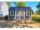 Exterior view of an outbuilding with double doors, windows, and dark trim at 303 Caroline Ave, Lowell, NC 28098
