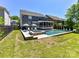 Backyard view of a pool and spa area featuring patio seating and lush green lawn at 3057 Drummond Ave, Indian Land, SC 29707
