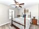 Cozy bedroom featuring four poster bed, soft bedding, natural lighting, and neutral paint at 3057 Drummond Ave, Indian Land, SC 29707