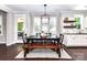 Bright dining room with pendant lighting and backyard access offers a rustic wood table with bench seating at 3057 Drummond Ave, Indian Land, SC 29707
