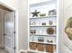 Hallway bookcase featuring organized shelves with decor and storage baskets at 3057 Drummond Ave, Indian Land, SC 29707