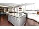 Open concept kitchen with gray island, granite countertops, and stainless appliances overlooks eat-in area at 3057 Drummond Ave, Indian Land, SC 29707