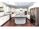 Bright kitchen features an island, stainless steel appliances, and white cabinets with granite countertops at 3057 Drummond Ave, Indian Land, SC 29707