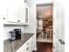 Open butler's pantry with granite counters leads to the dining room at 3057 Drummond Ave, Indian Land, SC 29707