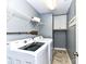 Laundry room includes modern washer and dryer units, overhead shelving, and cabinet storage at 3057 Drummond Ave, Indian Land, SC 29707