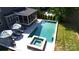 An aerial view of a pristine pool and jacuzzi with lounge seating, offering a private outdoor oasis at 3057 Drummond Ave, Indian Land, SC 29707