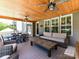 Spacious screened porch with ceiling fans, comfortable seating, and a dining table at 3057 Drummond Ave, Indian Land, SC 29707