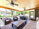 Inviting screened-in porch with multiple seating areas and great views of the backyard at 3057 Drummond Ave, Indian Land, SC 29707