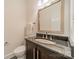 Bathroom featuring vanity with granite countertop, a modern sink, and a framed mirror at 3233 Sunnymede Ln, Charlotte, NC 28209