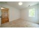 Cozy bedroom with neutral paint, a window, and a closet at 3233 Sunnymede Ln, Charlotte, NC 28209