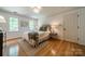 Charming bedroom filled with natural light boasts hardwood floors, rug, queen bed, and neutral decor at 3233 Sunnymede Ln, Charlotte, NC 28209