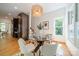 Bright dining area with a modern glass-top table, stylish chairs, and a unique woven chandelier at 3233 Sunnymede Ln, Charlotte, NC 28209