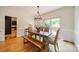 Elegant dining room with light walls, hardwood floors, and a modern bench-style dining set at 3233 Sunnymede Ln, Charlotte, NC 28209