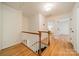 Upstairs hallway with hardwood floors and white trim at 3233 Sunnymede Ln, Charlotte, NC 28209