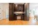 Elegant kitchen featuring custom dark wood cabinets, granite countertops, and stainless steel appliances at 3233 Sunnymede Ln, Charlotte, NC 28209