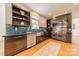 Well-equipped kitchen with stainless steel appliances, dark cabinets, and hardwood floors at 3233 Sunnymede Ln, Charlotte, NC 28209