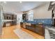 Spacious kitchen with dark cabinetry, stainless steel appliances, and hardwood floors at 3233 Sunnymede Ln, Charlotte, NC 28209
