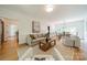 Open-concept living room with hardwood floors connecting to the dining area at 3233 Sunnymede Ln, Charlotte, NC 28209