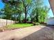 Spacious backyard with lush greenery, mature trees, and a concrete patio, perfect for outdoor enjoyment at 3317 Sargeant Dr, Charlotte, NC 28217
