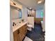 Bright bathroom featuring a modern vanity, standalone tub, and elegant tiling at 3317 Sargeant Dr, Charlotte, NC 28217