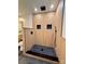 Walk-in shower featuring stylish wood-paneled walls, black fixtures, and modern design at 3317 Sargeant Dr, Charlotte, NC 28217