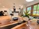 Modern dining area with a hardwood table, seating, and access to a bright kitchen with white cabinetry at 3317 Sargeant Dr, Charlotte, NC 28217