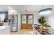 Bright dining area featuring modern lighting, wood table, and french doors leading to outdoor space at 3317 Sargeant Dr, Charlotte, NC 28217