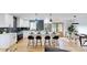 Bright kitchen showcasing white cabinets, a marble countertop island with seating, and modern stainless steel appliances at 3317 Sargeant Dr, Charlotte, NC 28217