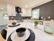 Stylish kitchen with white cabinets, a marble countertop, and a backsplash arranged in a herringbone pattern at 3317 Sargeant Dr, Charlotte, NC 28217