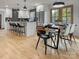 Bright, modern kitchen with white cabinets, stainless steel appliances, a marble countertop island, and a dining space at 3317 Sargeant Dr, Charlotte, NC 28217