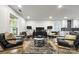 Modern living room featuring a black media console, modern furniture, hardwood floors, and access to the kitchen at 3317 Sargeant Dr, Charlotte, NC 28217