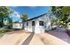Rear exterior view of a white painted home featuring a patio, dark window trim, and manicured landscape at 3317 Sargeant Dr, Charlotte, NC 28217