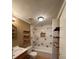 Cozy bathroom with tub-shower combo and charming wood shelving at 36 Maple Ave, Gastonia, NC 28054