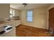 Bright kitchen featuring white cabinetry, white subway tile, and wood flooring at 36 Maple Ave, Gastonia, NC 28054