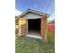 Outbuilding provides ample storage with wide wooden doors, accessible from the yard at 36 Maple Ave, Gastonia, NC 28054