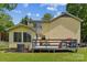 Exterior back view showcasing a sunroom and deck, offering great outdoor living at 3619 Baywoods Ct, Gastonia, NC 28056
