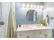 Bathroom with double sinks, shower with decorative curtain, and modern fixtures at 3619 Baywoods Ct, Gastonia, NC 28056