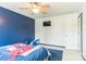 Bedroom with dark blue accent wall and tv mounted to the wall at 3619 Baywoods Ct, Gastonia, NC 28056