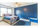 Bedroom with dark blue accent wall, large bed, and side table at 3619 Baywoods Ct, Gastonia, NC 28056