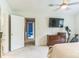 Bedroom with neutral carpet, tv mounted to the wall, and small exercise bike at 3619 Baywoods Ct, Gastonia, NC 28056
