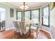 Elegant dining room with large windows and a glass table with decorative chair covers at 3619 Baywoods Ct, Gastonia, NC 28056