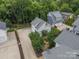 Aerial view of the property showing the house, garage, driveway, and surrounding trees at 365 Delburg St, Davidson, NC 28036