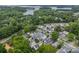 Scenic aerial view of homes surrounded by lush greenery near a serene lake at 365 Delburg St, Davidson, NC 28036